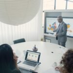 Professional team engaged in a business presentation in a modern office setting.